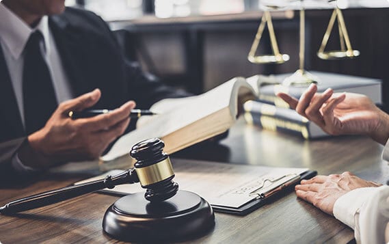 A man stands before a judge in a courtroom.