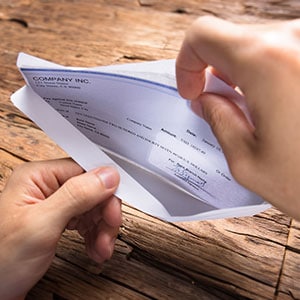 A person holding a document in their hand - Levian Law