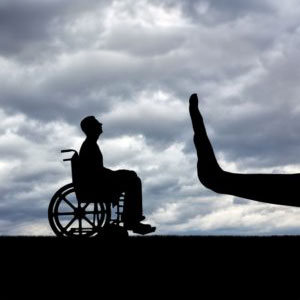 A person in a wheelchair and a hand stop - Levian Law