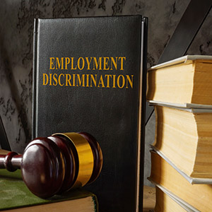 Employment discrimination law book, gavel, and books for LGBT workplace case in California.