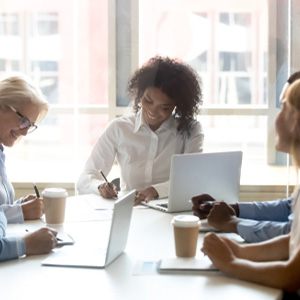 Diverse group of people and a mediator in a workplace discrimination session
